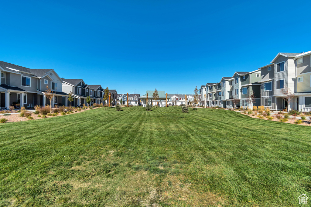 Surrounding community with a residential view and a lawn