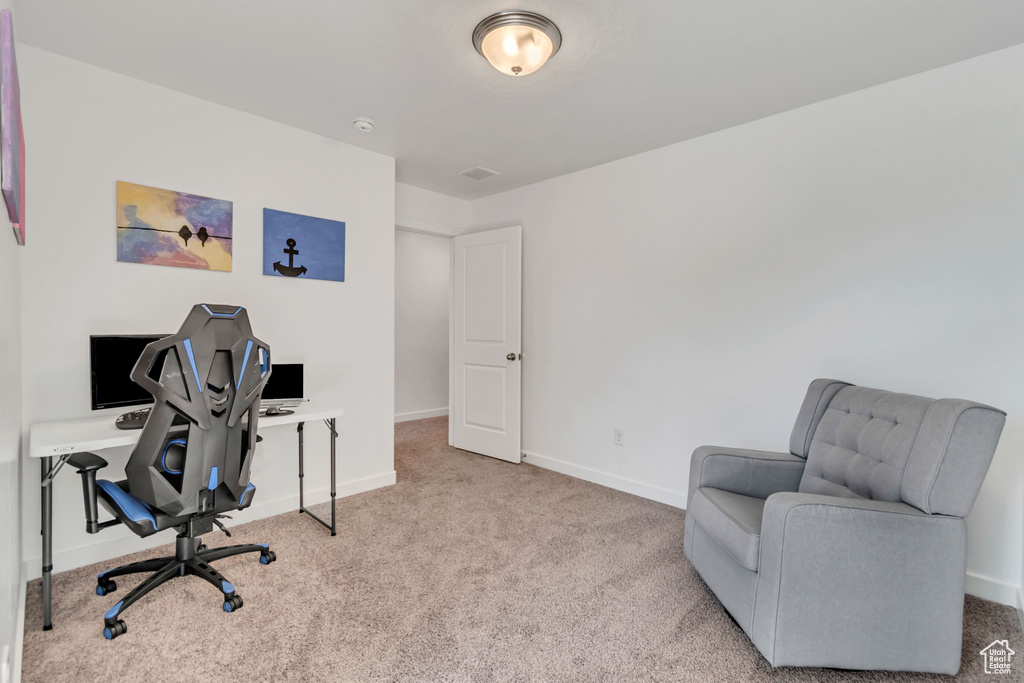 Carpeted office space with baseboards