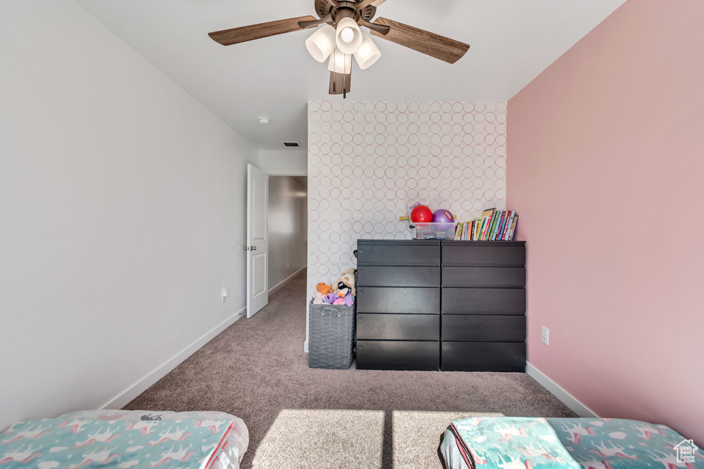 Bedroom featuring carpet flooring, baseboards, and a ceiling fan