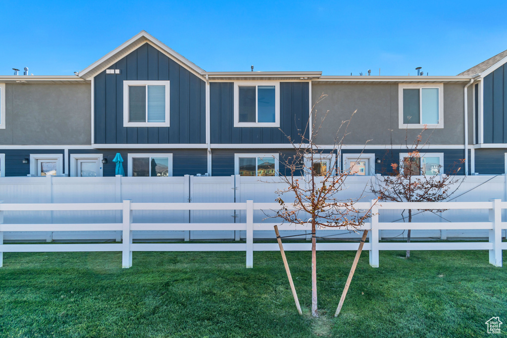 Rear view of property with board and batten siding