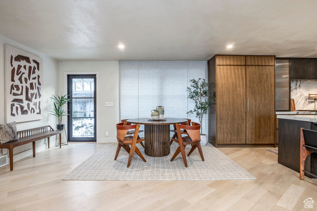 Dining space with light wood-type flooring and recessed lighting