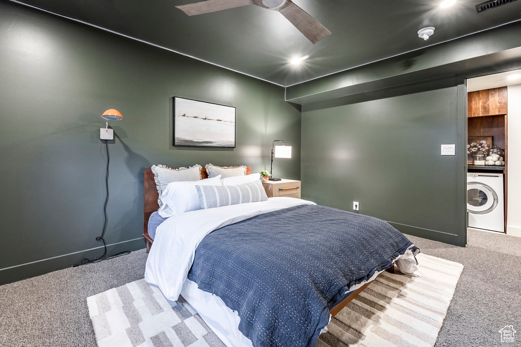 Carpeted bedroom with washer / clothes dryer, baseboards, and a ceiling fan
