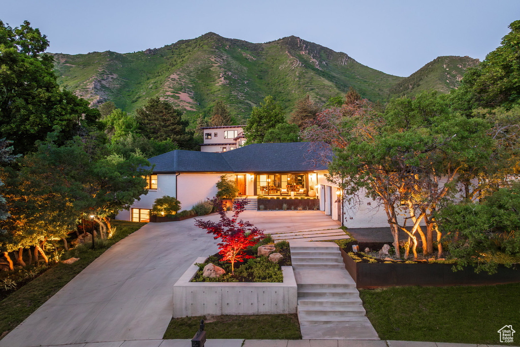 View of front of home with a mountain view and stucco siding