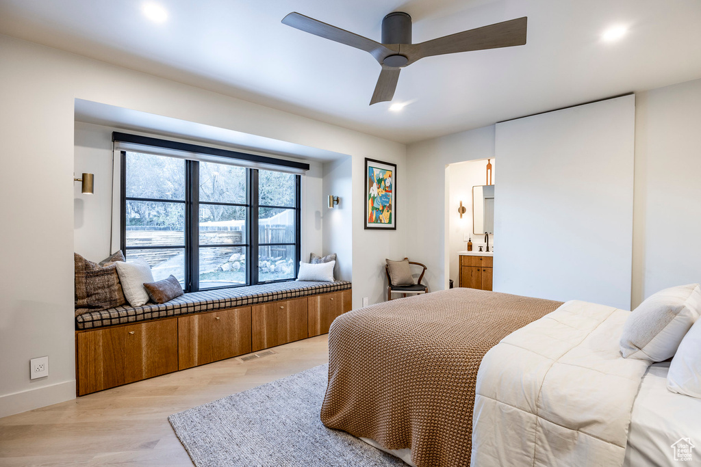 Bedroom featuring light wood-type flooring, recessed lighting, baseboards, ensuite bath, and ceiling fan