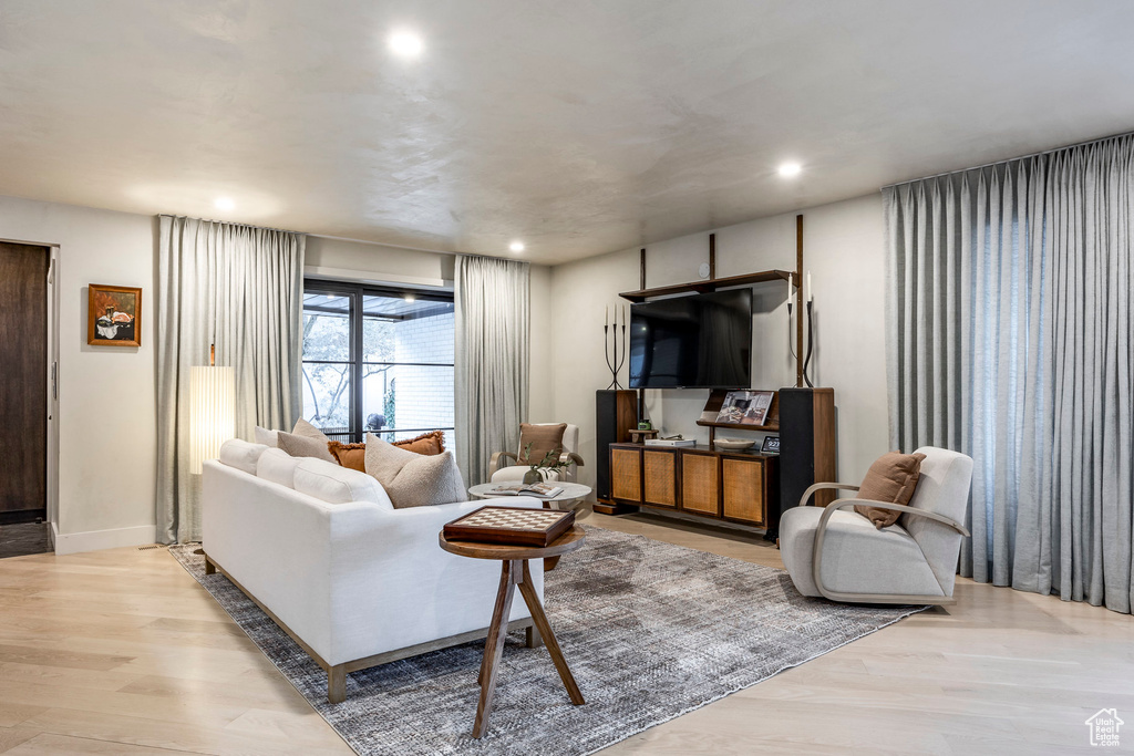 Living area featuring light wood-type flooring and recessed lighting