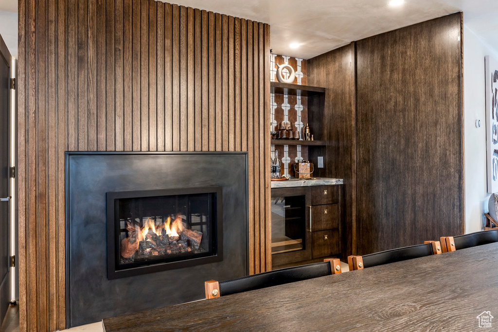 Bar with a warm lit fireplace and recessed lighting