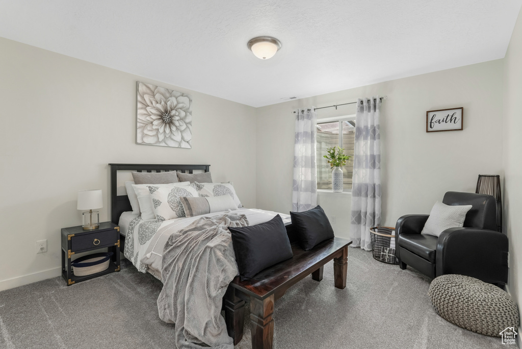 Carpeted bedroom featuring baseboards
