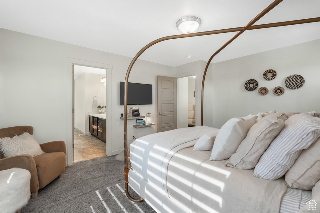 Bedroom featuring carpet floors and connected bathroom