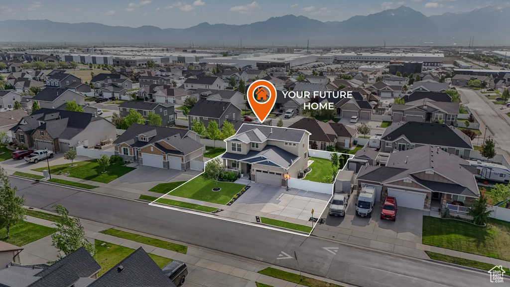Aerial view of residential area featuring a mountainous background