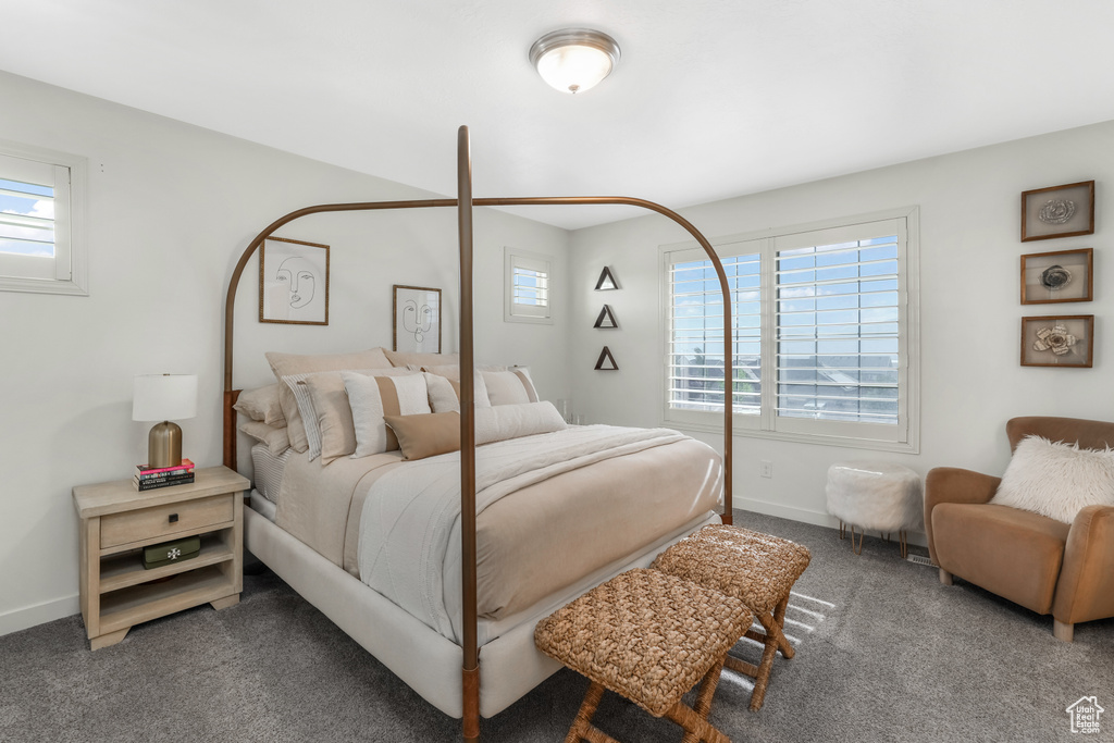 Bedroom featuring carpet and baseboards