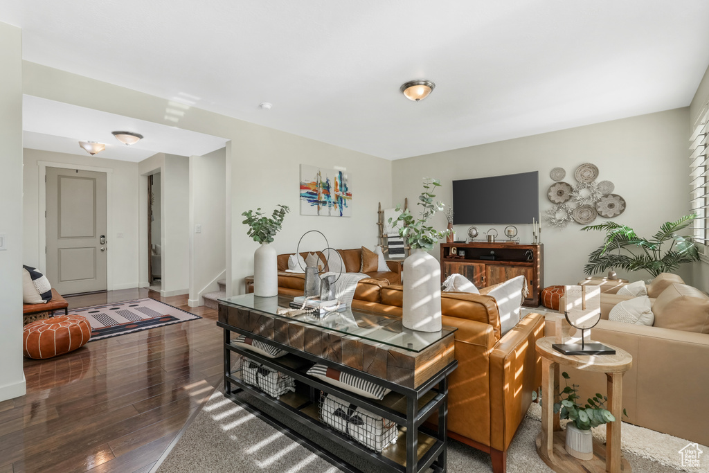 Living room with hardwood / wood-style floors and stairs