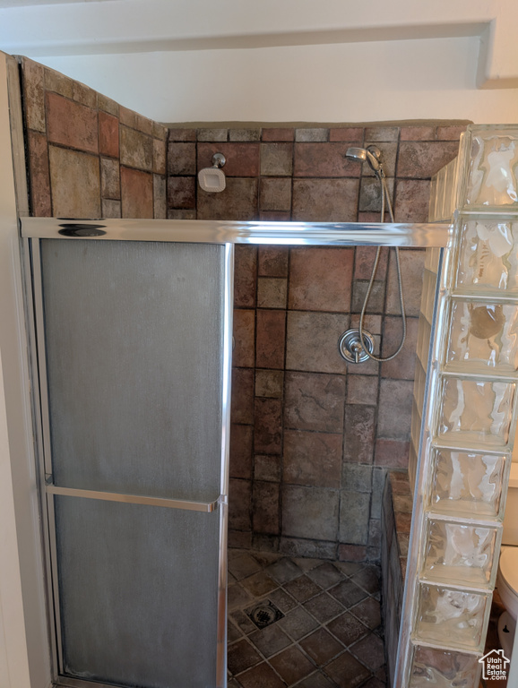 Bathroom with a shower stall and toilet