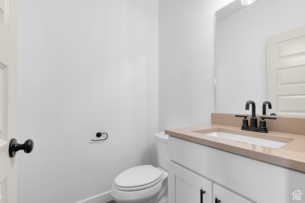 Bathroom featuring vanity and toilet