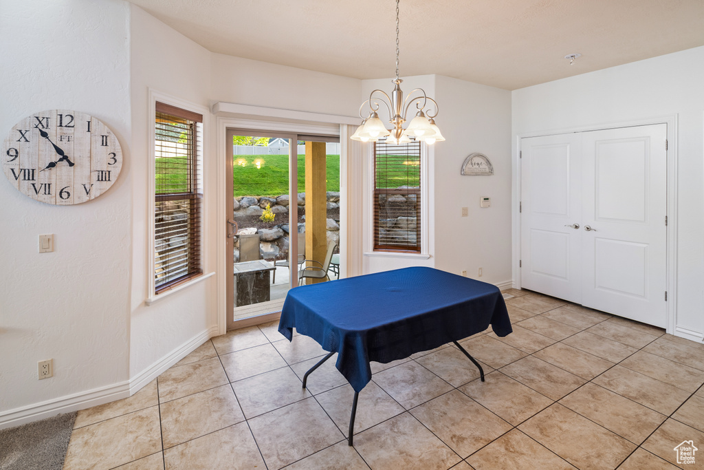 Rec room with a chandelier, light tile patterned flooring, and baseboards