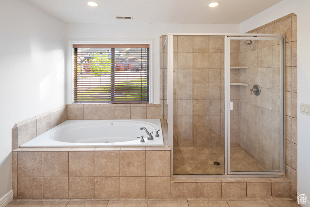 Bathroom with a garden tub, a shower stall, and recessed lighting