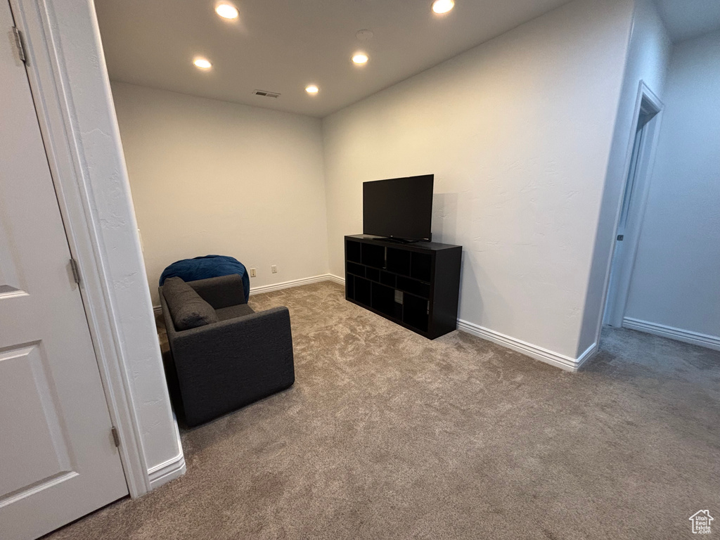 Living area with carpet, recessed lighting, and baseboards