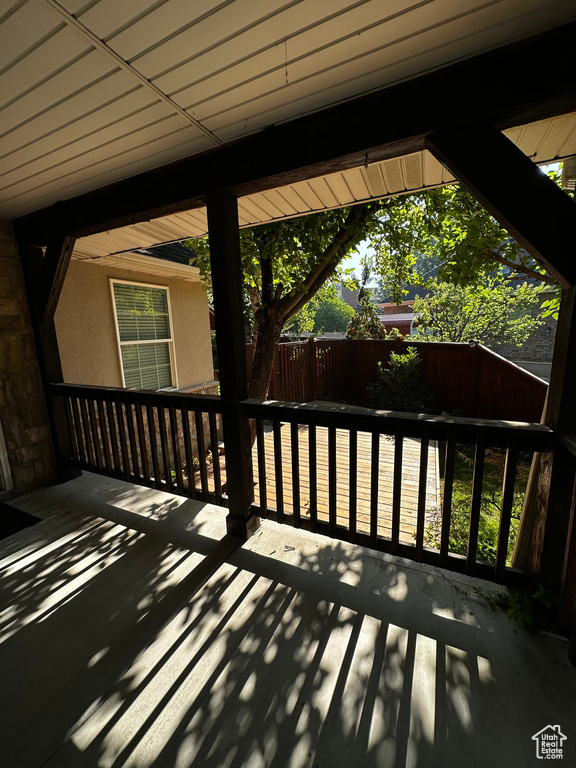 Wooden deck with a fenced backyard