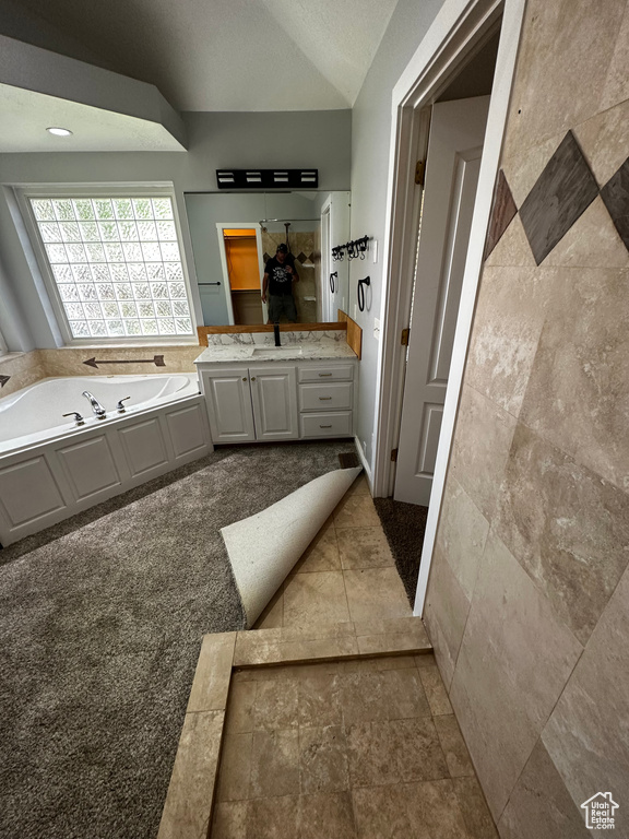 Full bathroom with a garden tub and vanity