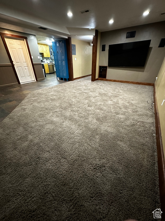 Basement with recessed lighting, dark carpet, and baseboards