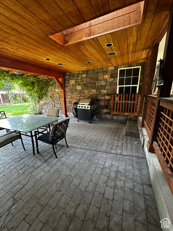 View of patio / terrace with grilling area, outdoor dining area, and a deck