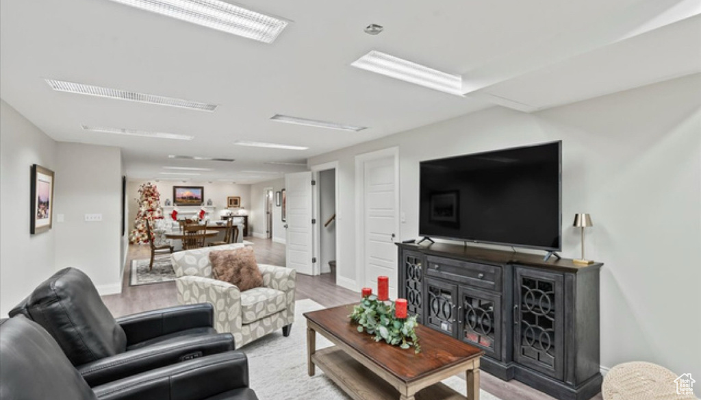 Living area featuring baseboards and wood finished floors