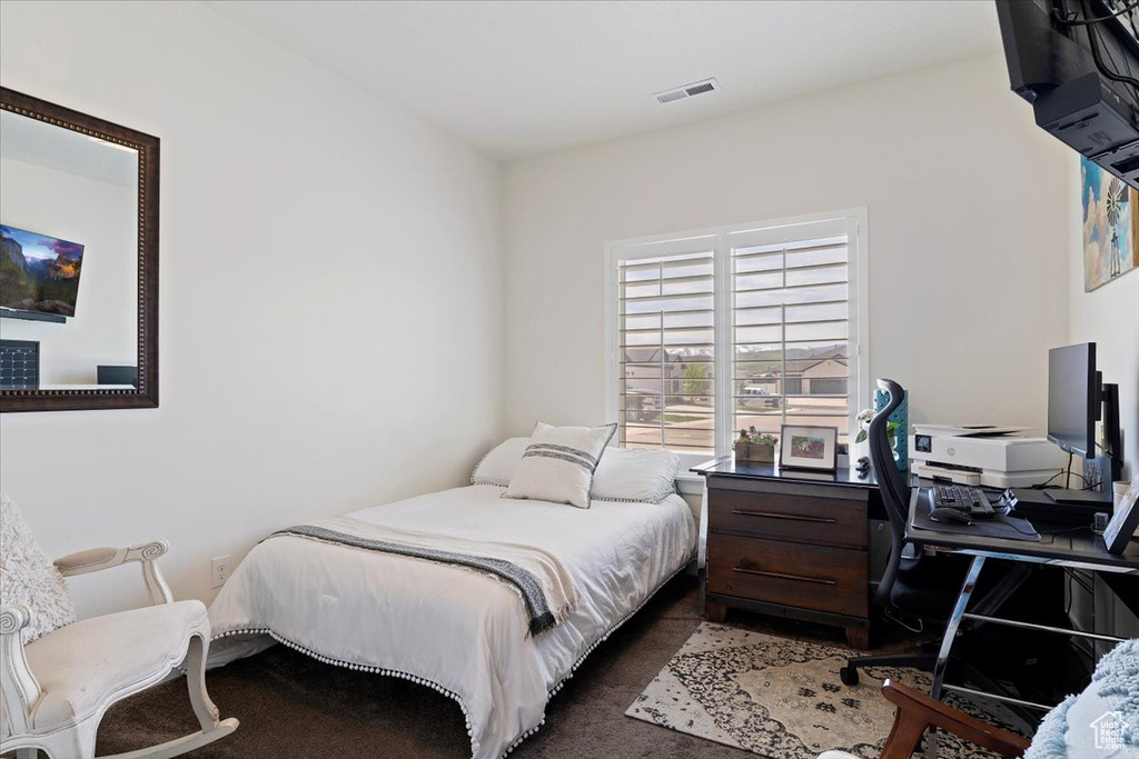 Bedroom featuring a desk and carpet flooring