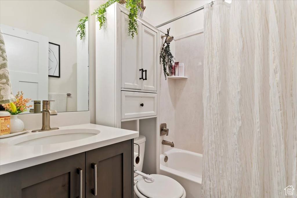 Full bathroom with shower / bath combo, toilet, and vanity