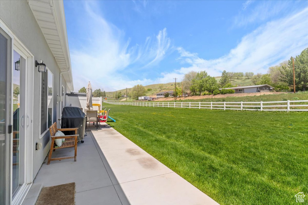 View of yard with a rural view and a patio area