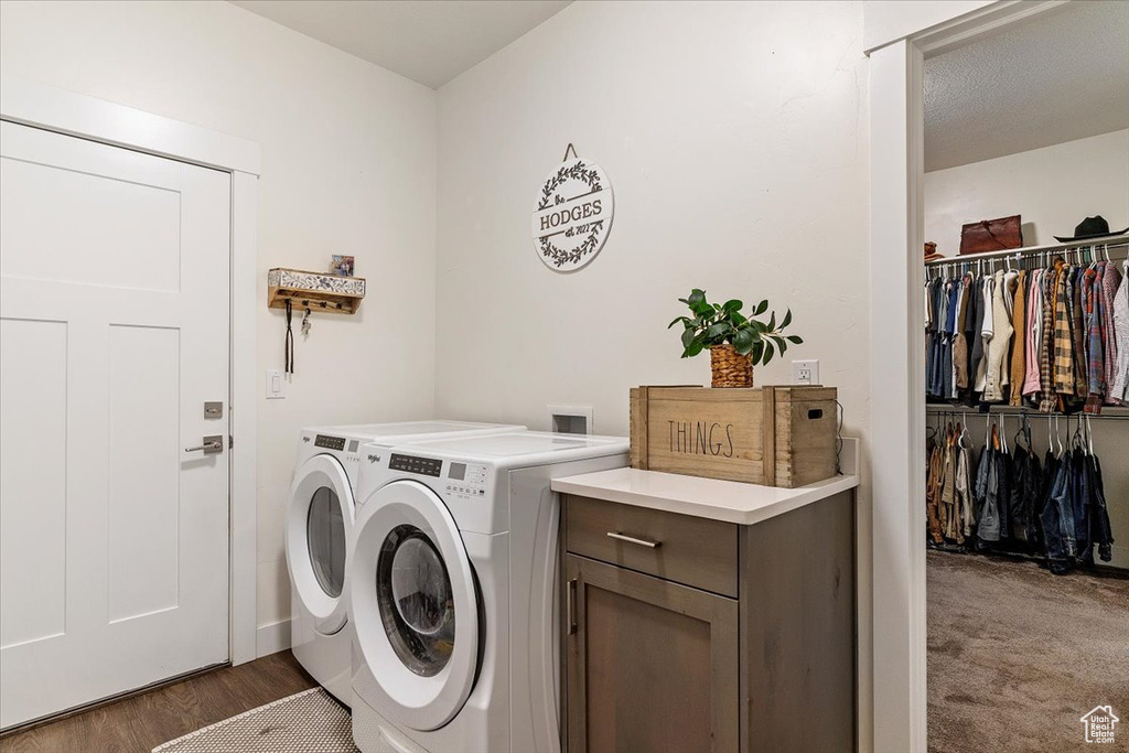 Laundry area featuring washing machine and clothes dryer and wood finished floors