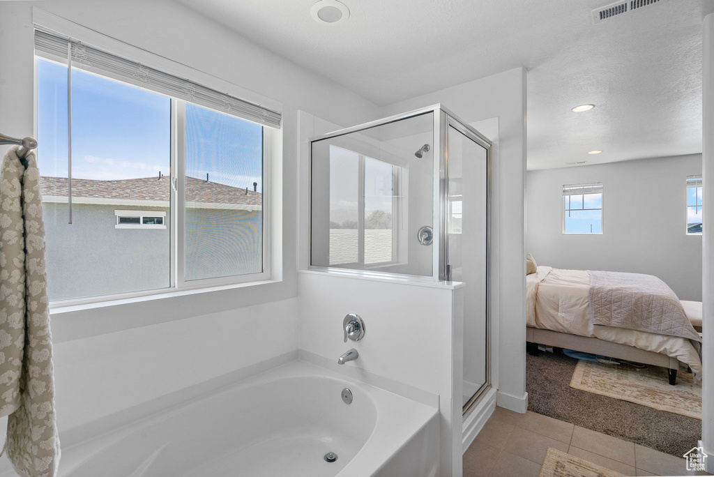 Full bathroom featuring a stall shower, a bath, connected bathroom, tile patterned floors, and recessed lighting