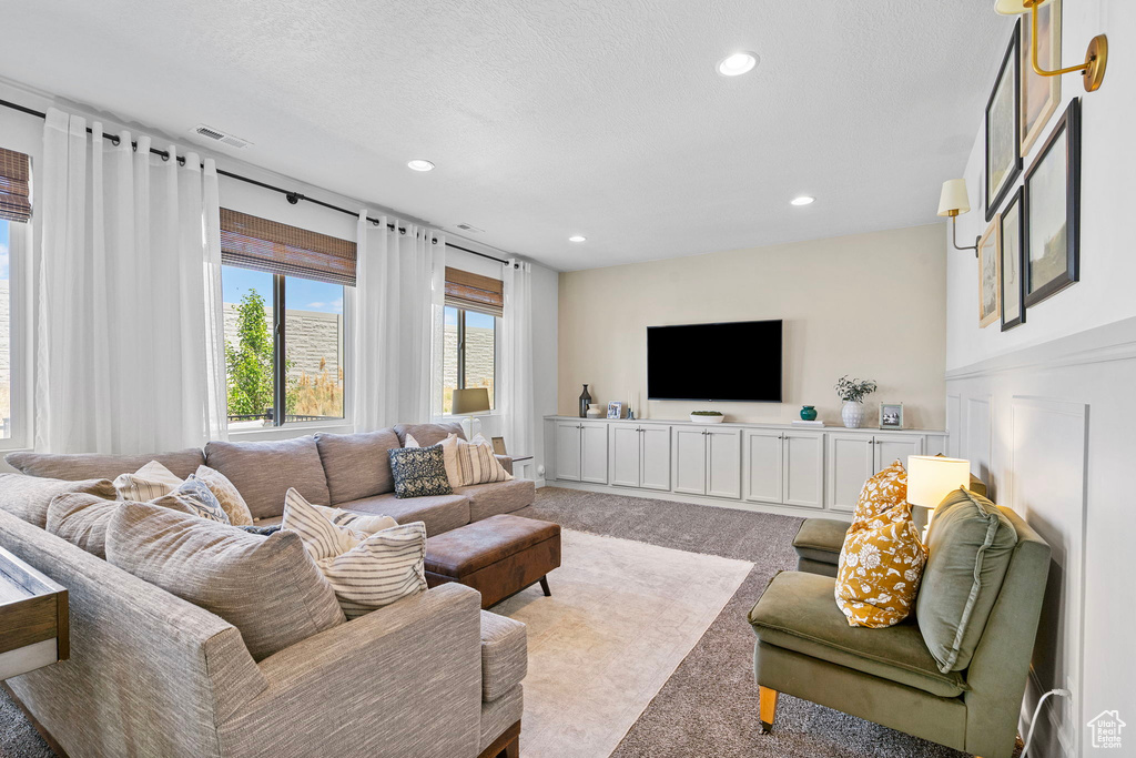 Carpeted living room with recessed lighting