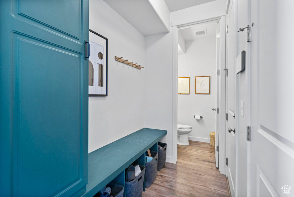 Mudroom featuring wood finished floors and baseboards