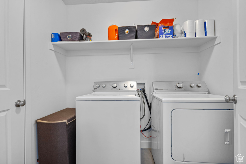 Clothes washing area featuring washer and clothes dryer