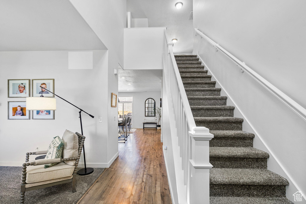 Stairs with wood-type flooring and baseboards