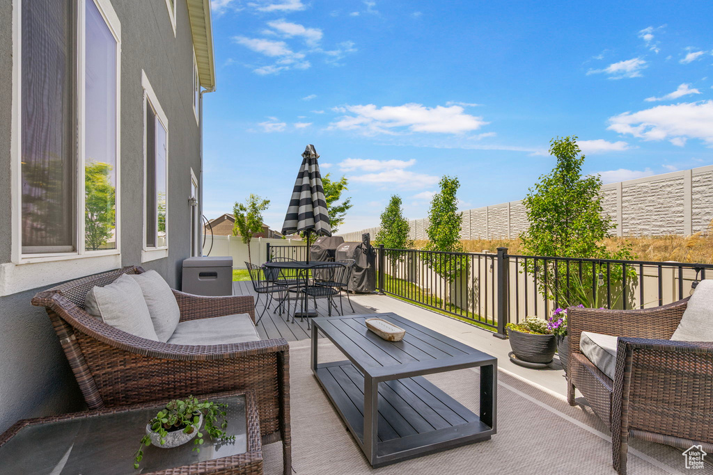 Wooden terrace featuring outdoor dining space and an outdoor living space
