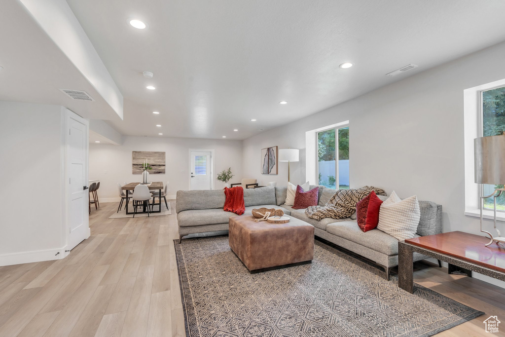Living area with light wood-style floors, recessed lighting, and baseboards