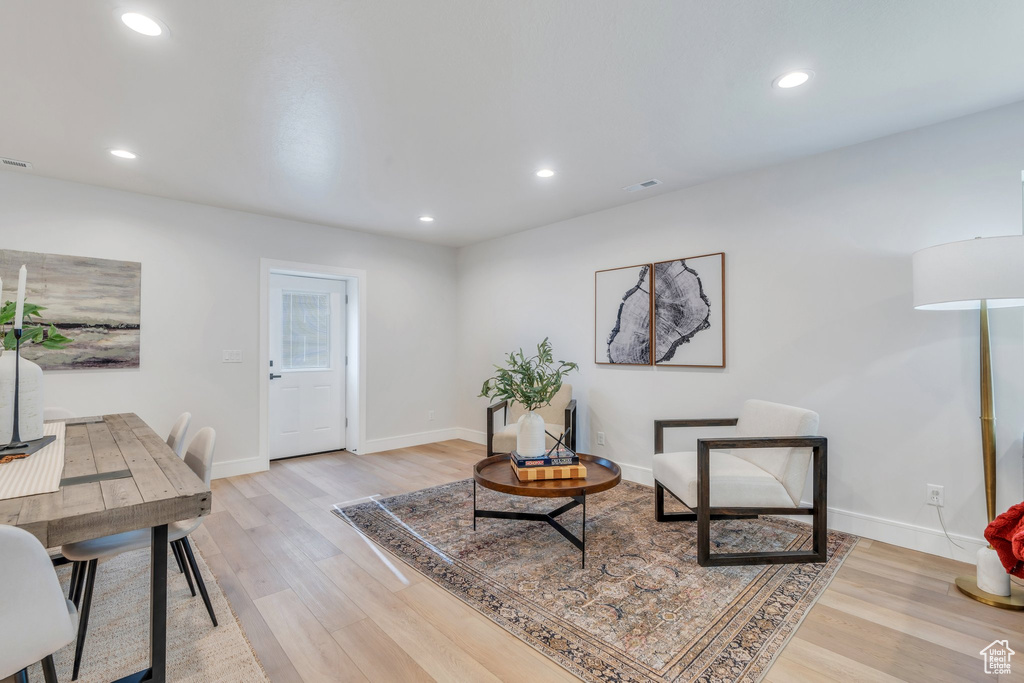 Sitting room with light wood-style flooring, baseboards, and recessed lighting