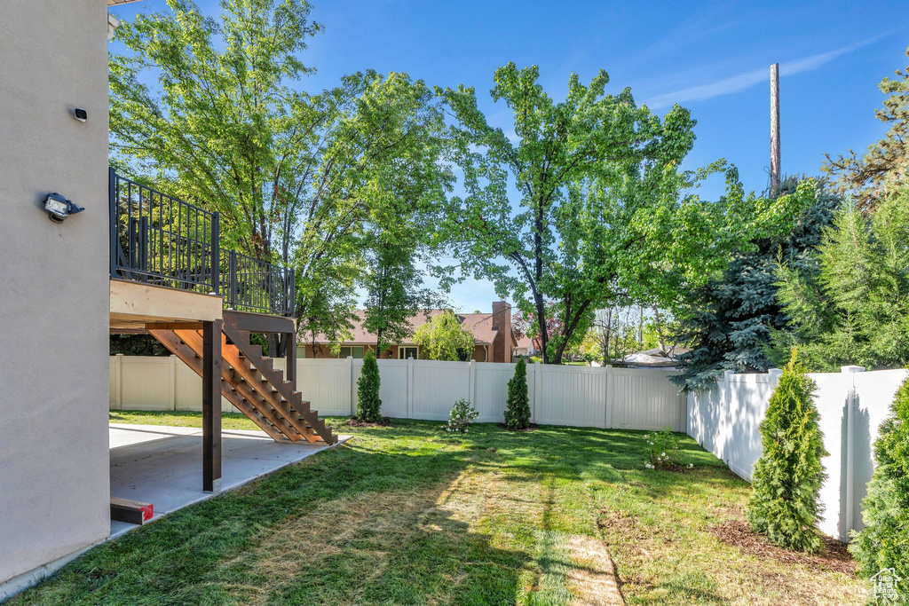View of yard with a patio and stairs