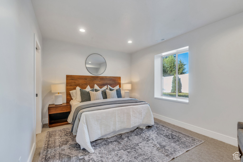 Carpeted bedroom with baseboards and recessed lighting