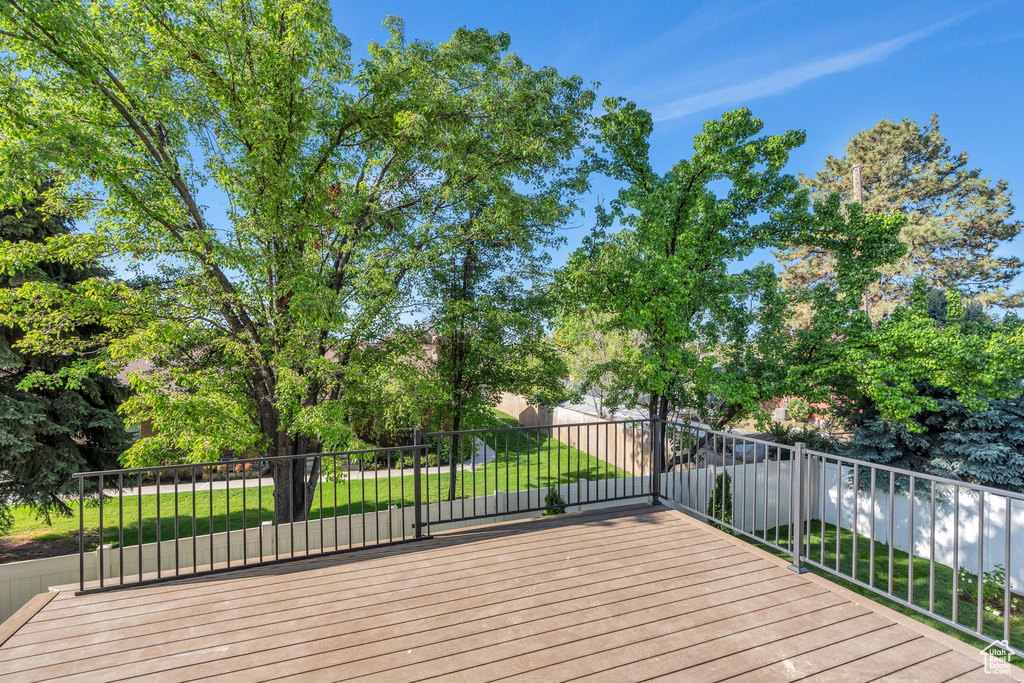 Wooden deck featuring a lawn
