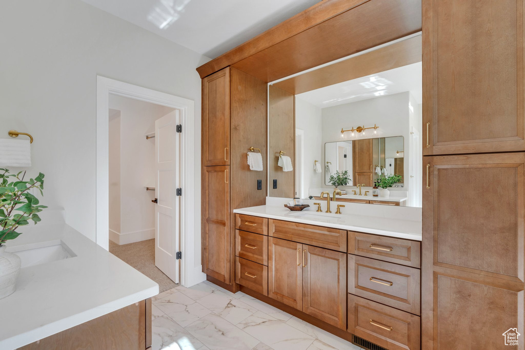 Bathroom featuring vanity and marble look tile flooring