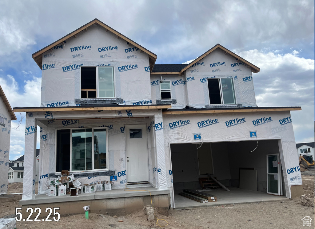 Unfinished property featuring an attached garage