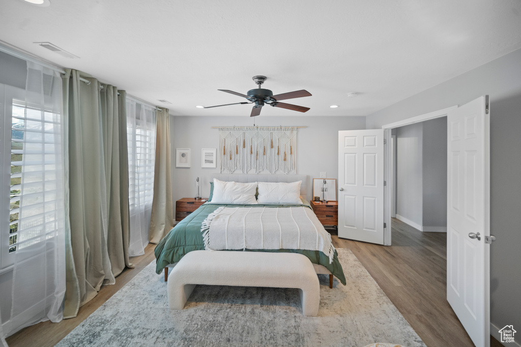 Bedroom with wood finished floors, recessed lighting, a ceiling fan, and baseboards