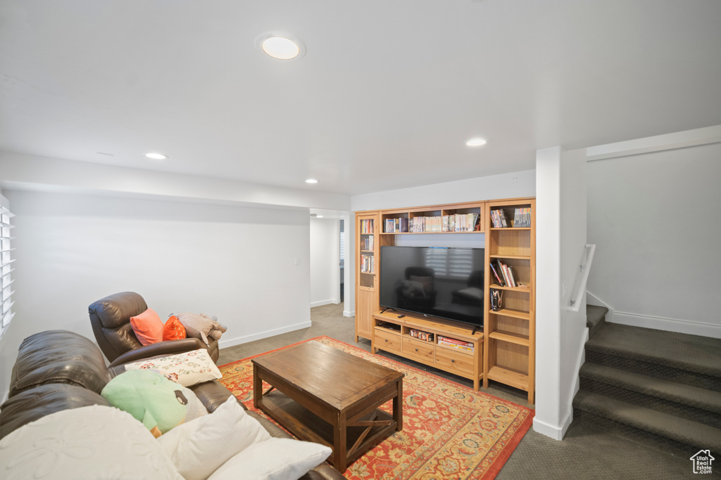 Carpeted living room with recessed lighting, stairway, and baseboards