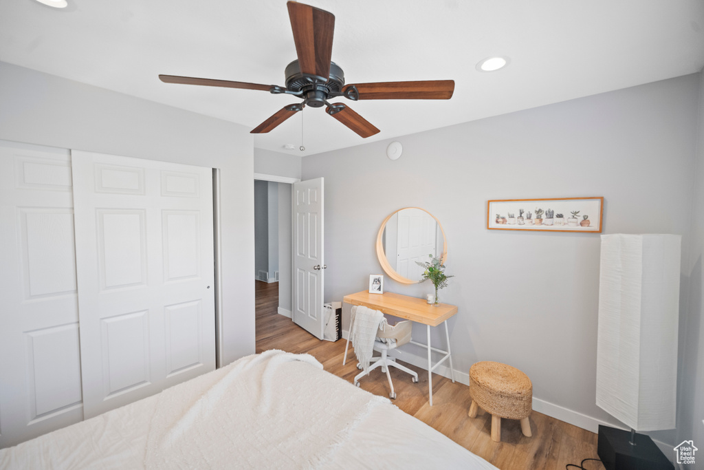 Bedroom featuring baseboards, recessed lighting, wood finished floors, ceiling fan, and a closet