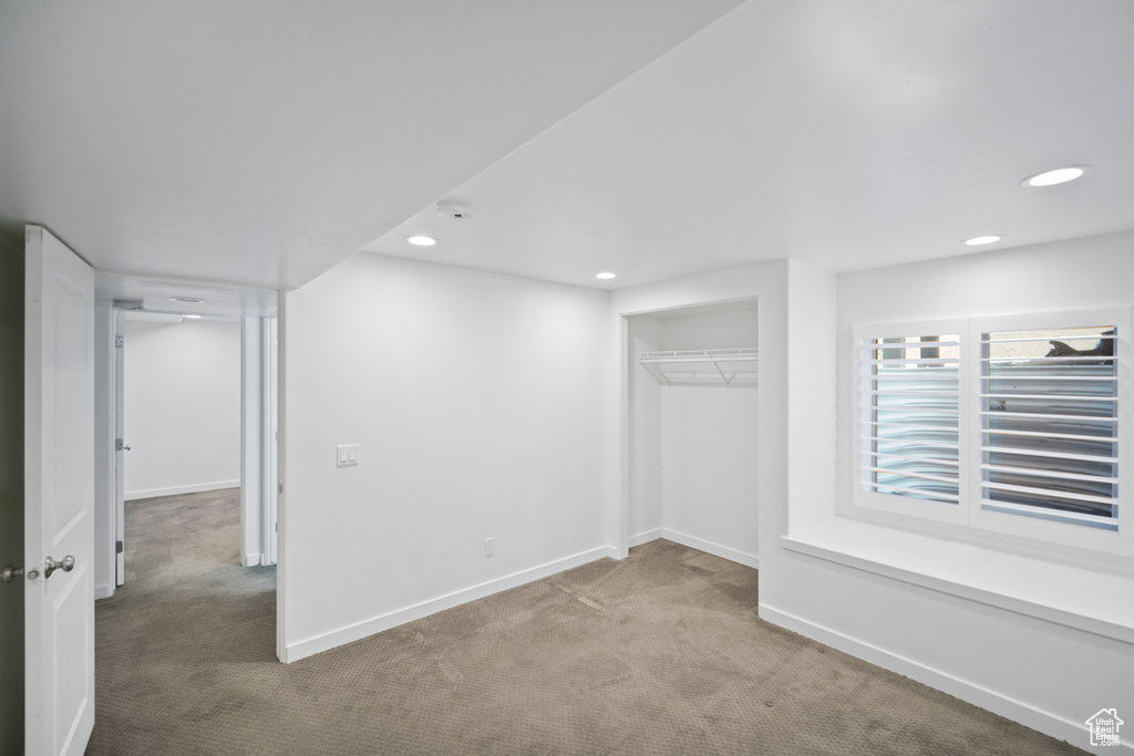 Below grade area featuring carpet floors, baseboards, and recessed lighting