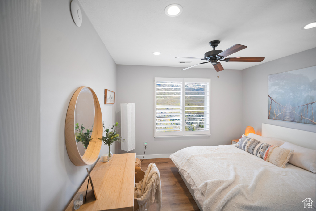Bedroom with recessed lighting, wood finished floors, baseboards, and ceiling fan