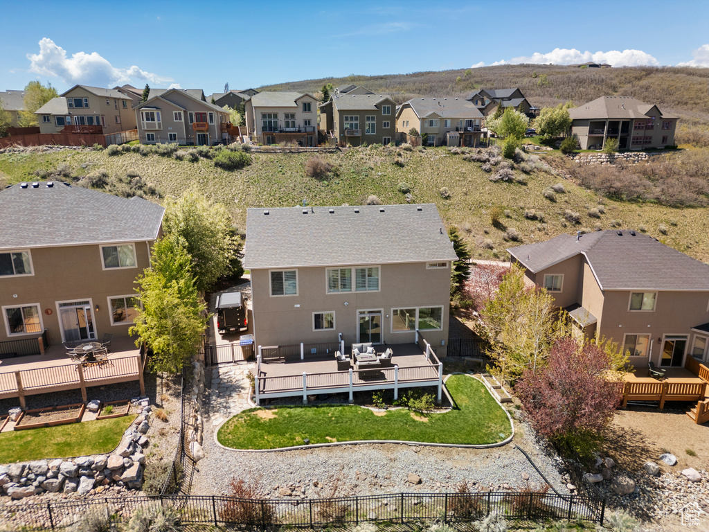 Rear view of property with a residential view and a deck