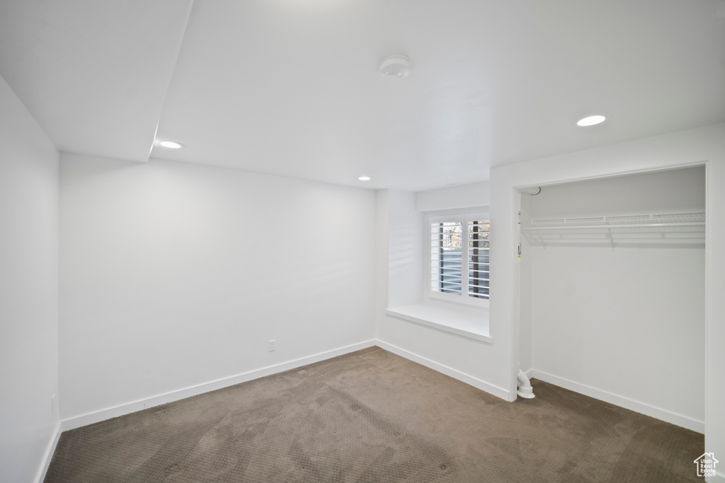 Unfurnished bedroom with carpet, recessed lighting, a closet, and baseboards