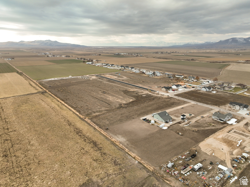 Aerial view of property and surrounding area with a mountainous background and rural landscape